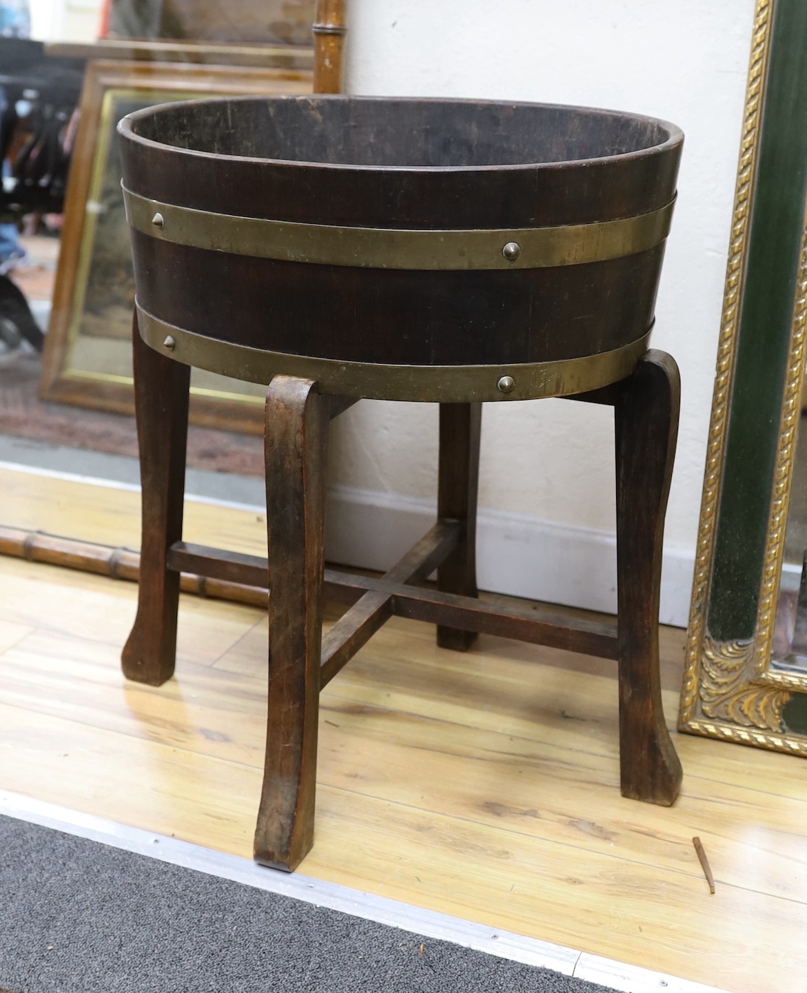 An early 20th century coopered oak planter and separate stand, stamped mark